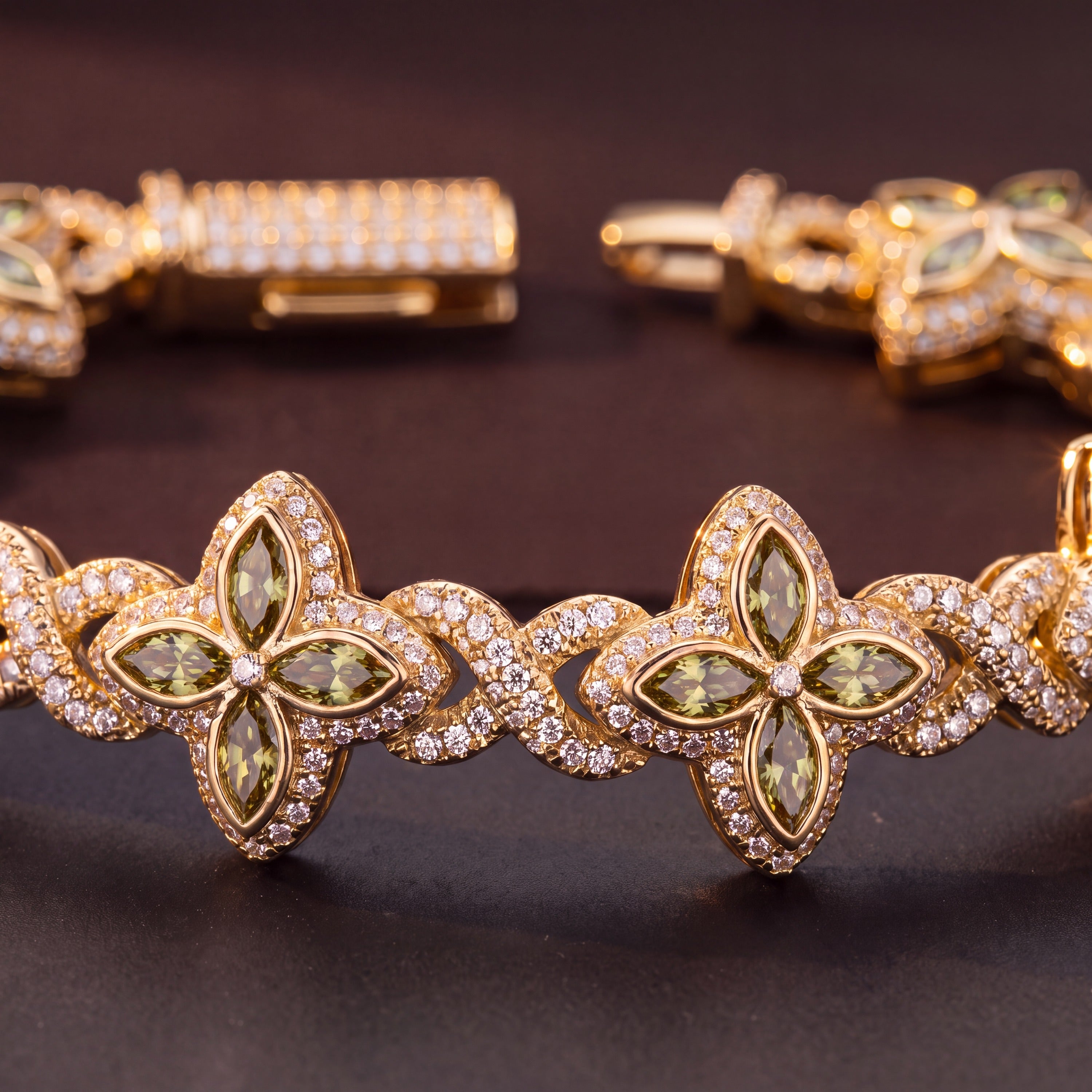 Close-up of olive-green marquise petals and the pave box clasp in gold tone